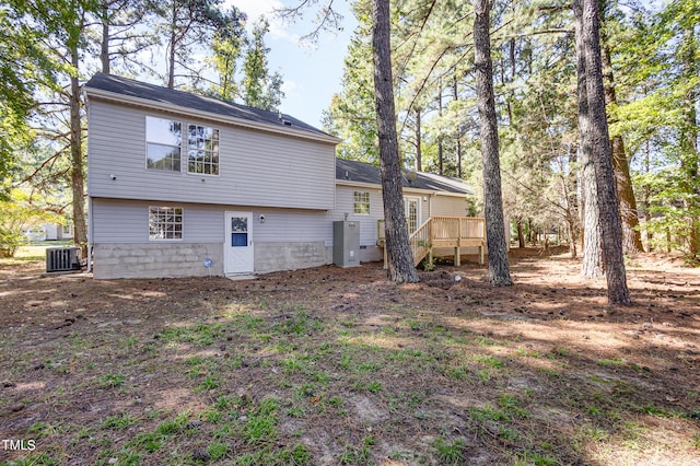 rear view of house with a deck and central AC unit