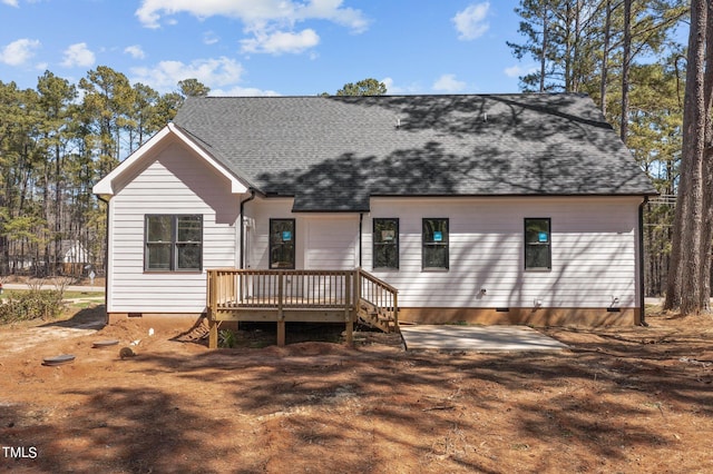 back of house with a deck