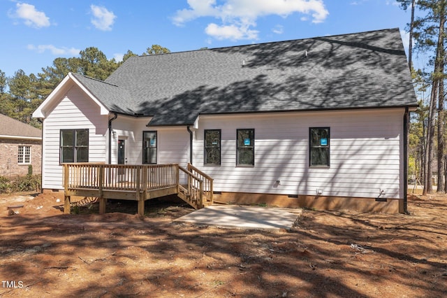 rear view of property featuring a deck