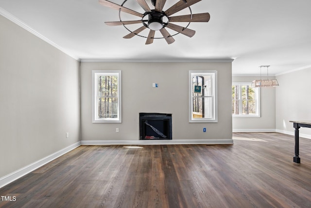 unfurnished living room featuring crown molding, dark wood-type flooring, and ceiling fan