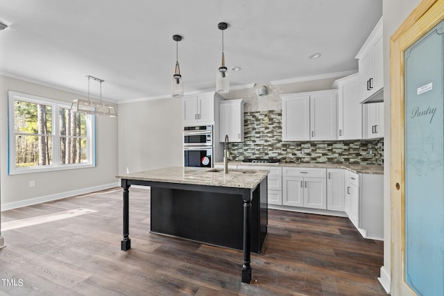 kitchen featuring tasteful backsplash, a breakfast bar, hanging light fixtures, and white cabinets