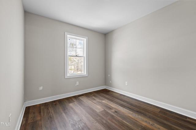 spare room with dark hardwood / wood-style floors