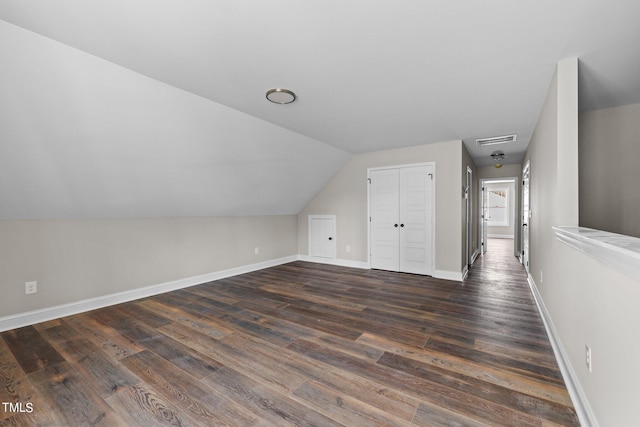 bonus room featuring lofted ceiling and dark wood-type flooring