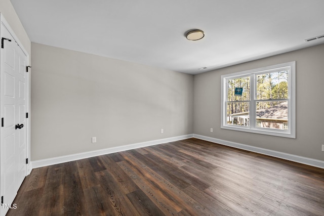 empty room featuring dark hardwood / wood-style flooring