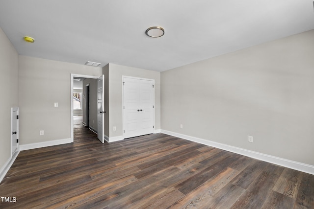 spare room with dark hardwood / wood-style flooring