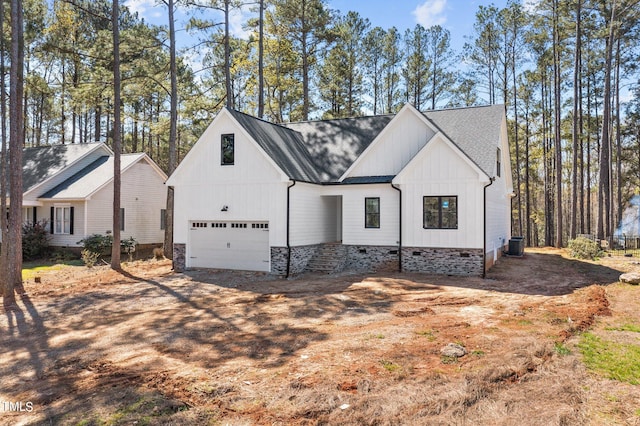 modern inspired farmhouse with a garage and central AC