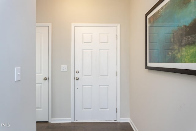 hallway with dark wood-type flooring