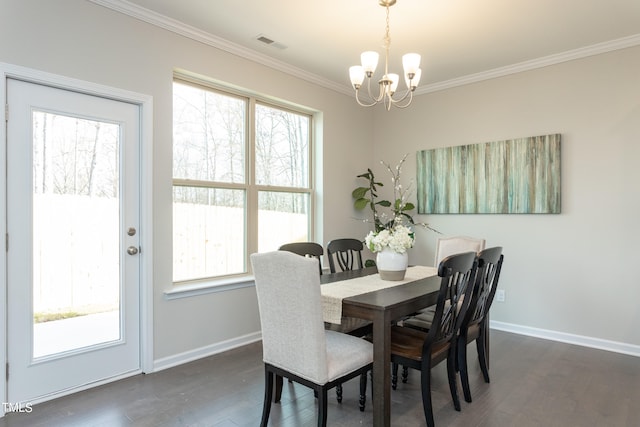 dining space featuring an inviting chandelier, ornamental molding, and dark hardwood / wood-style flooring