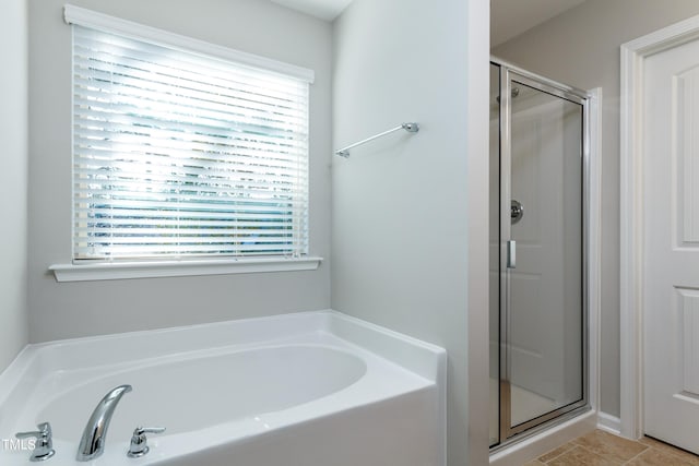 bathroom featuring shower with separate bathtub, tile floors, and plenty of natural light