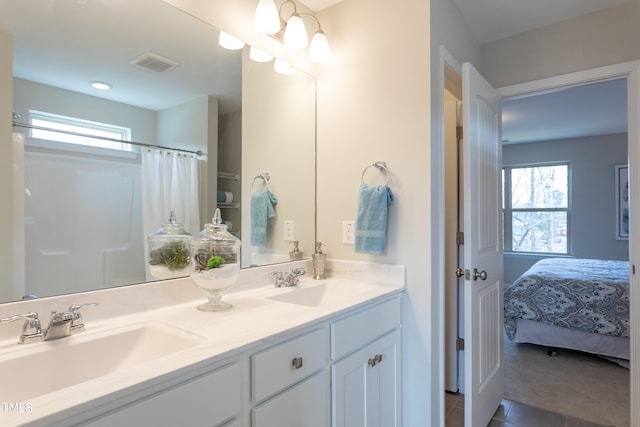 bathroom featuring tile flooring, dual sinks, and oversized vanity