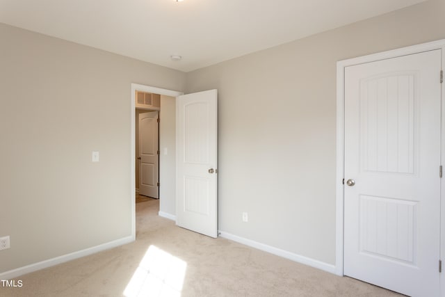 unfurnished bedroom featuring light carpet