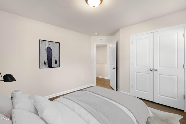 bedroom featuring wood-type flooring and a closet