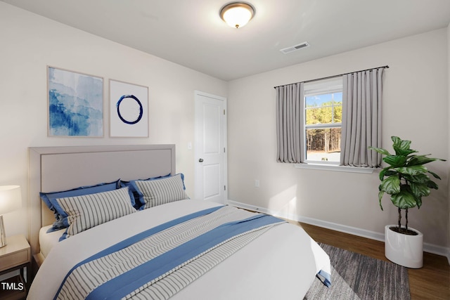 bedroom with dark wood-type flooring