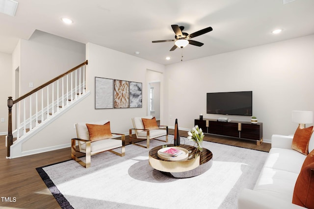 living room featuring hardwood / wood-style floors and ceiling fan