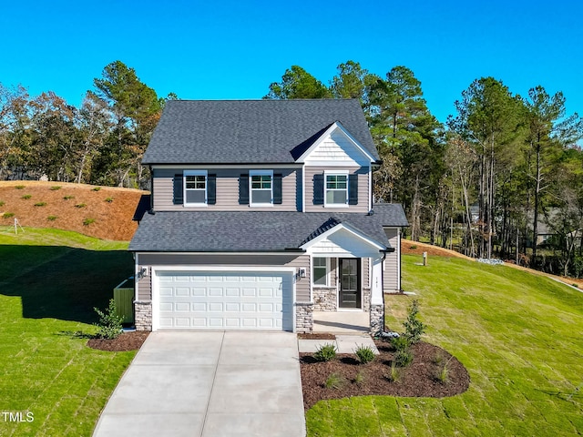 view of front of property with a garage and a front yard