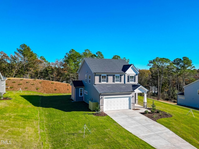 view of front property featuring a garage and a front lawn