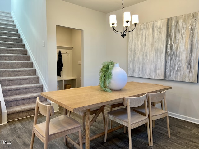 dining room featuring dark wood-type flooring and a notable chandelier