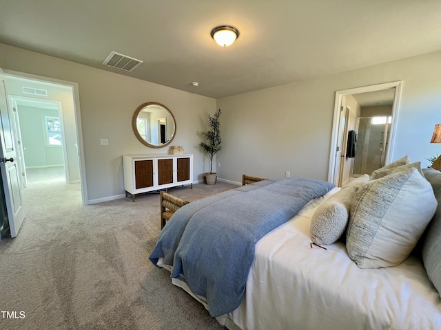 bedroom featuring ensuite bathroom and carpet flooring