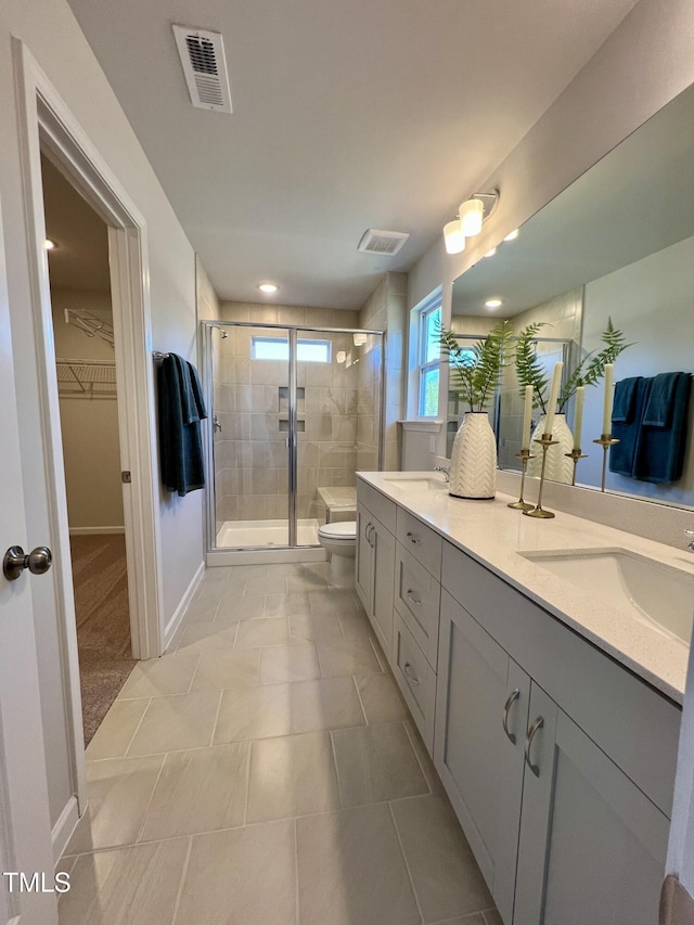 bathroom featuring toilet, vanity, and walk in shower