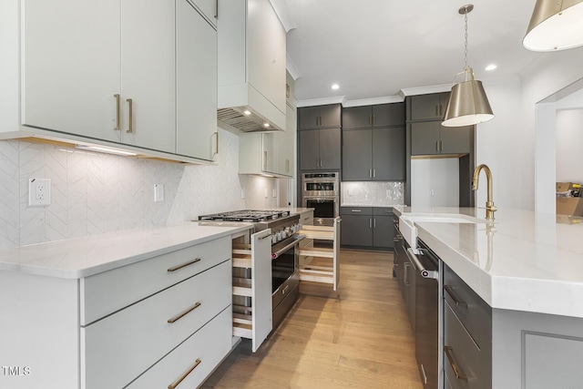 kitchen with appliances with stainless steel finishes, tasteful backsplash, hanging light fixtures, and gray cabinetry