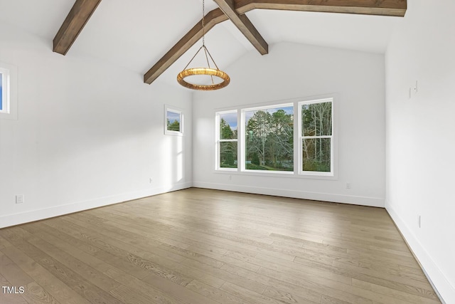 interior space featuring wood-type flooring and lofted ceiling with beams