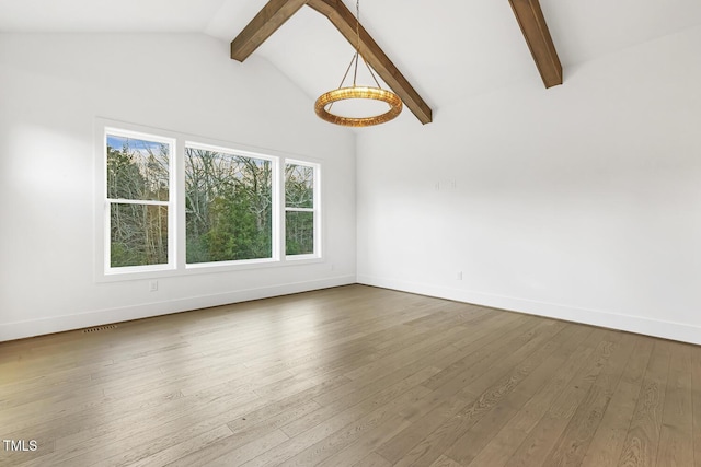 unfurnished living room featuring vaulted ceiling with beams and hardwood / wood-style floors