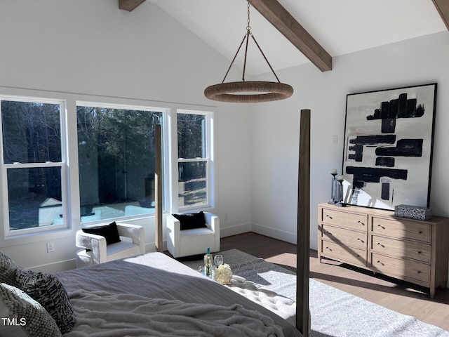 bedroom featuring hardwood / wood-style floors, vaulted ceiling with beams, and multiple windows