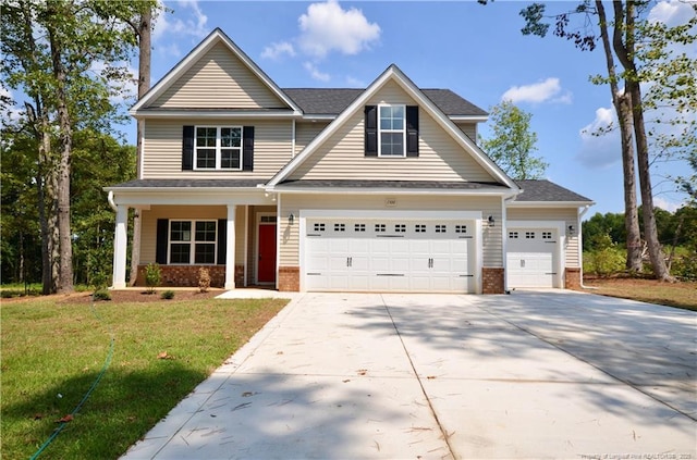 craftsman inspired home with a porch, a garage, and a front yard