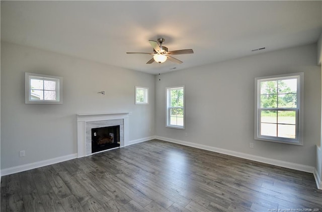 unfurnished living room with ceiling fan and dark hardwood / wood-style flooring