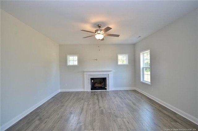 unfurnished living room with ceiling fan and hardwood / wood-style floors