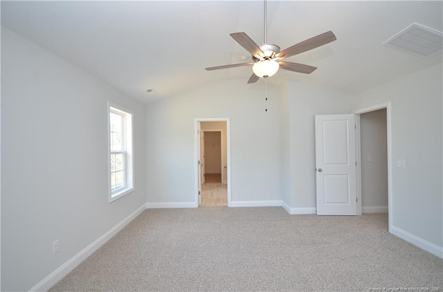 empty room with lofted ceiling and light colored carpet