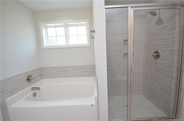 bathroom with shower with separate bathtub