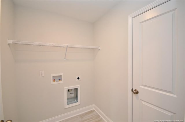 washroom featuring electric dryer hookup, hookup for a washing machine, and wood-type flooring