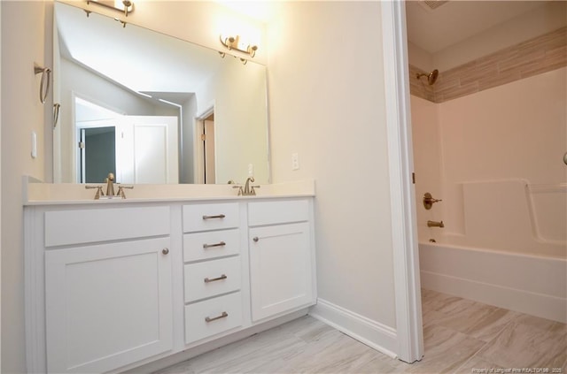 bathroom with vanity and  shower combination