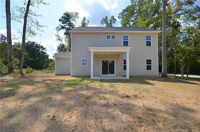 back of property with a patio and a lawn