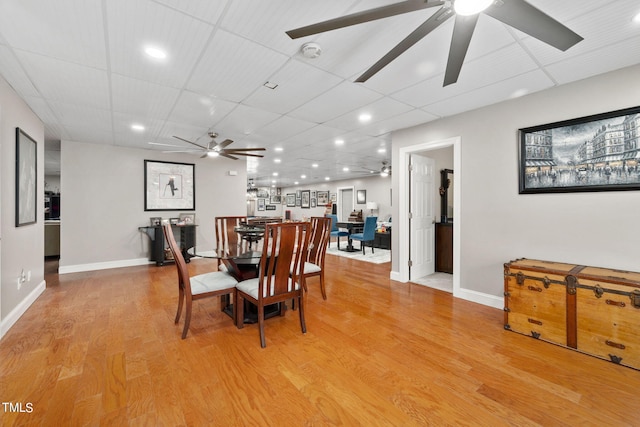 dining space featuring a paneled ceiling, light hardwood / wood-style floors, and ceiling fan