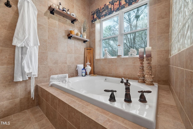 bathroom with tile walls, tiled tub, and tile flooring