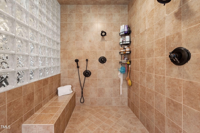 bathroom with a tile shower