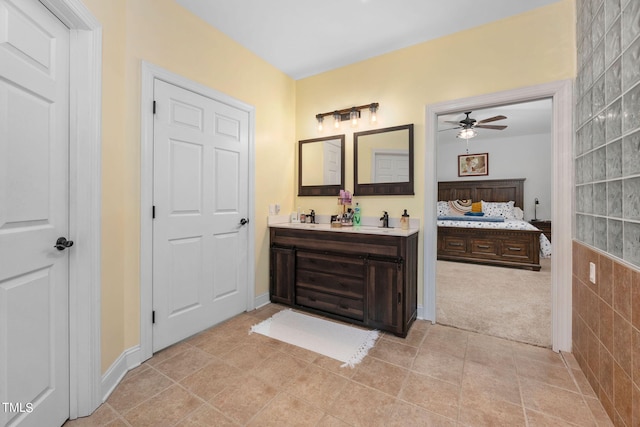 bathroom with tile floors, ceiling fan, and vanity