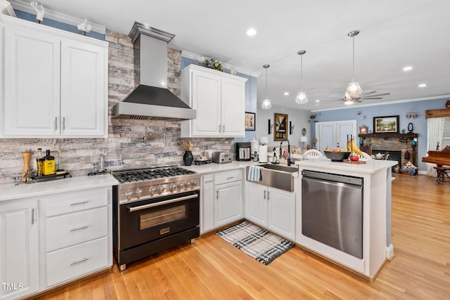 kitchen featuring light wood-type flooring, stainless steel dishwasher, black range with gas stovetop, and wall chimney exhaust hood