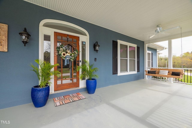 doorway to property with covered porch and ceiling fan