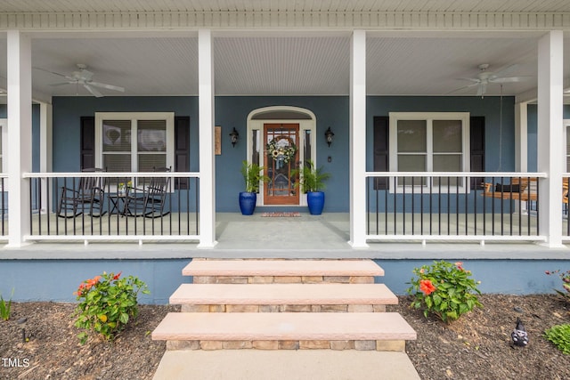 entrance to property with ceiling fan and covered porch