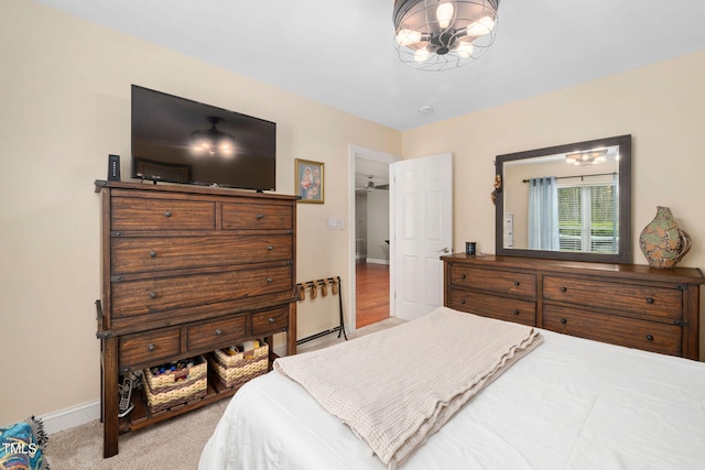 bedroom featuring a notable chandelier and light wood-type flooring