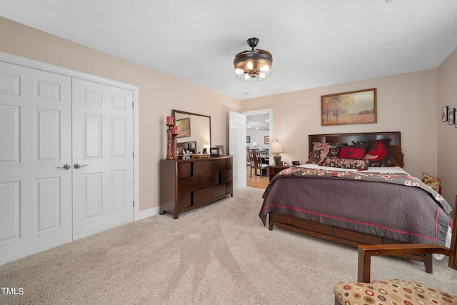 bedroom with a closet and light colored carpet