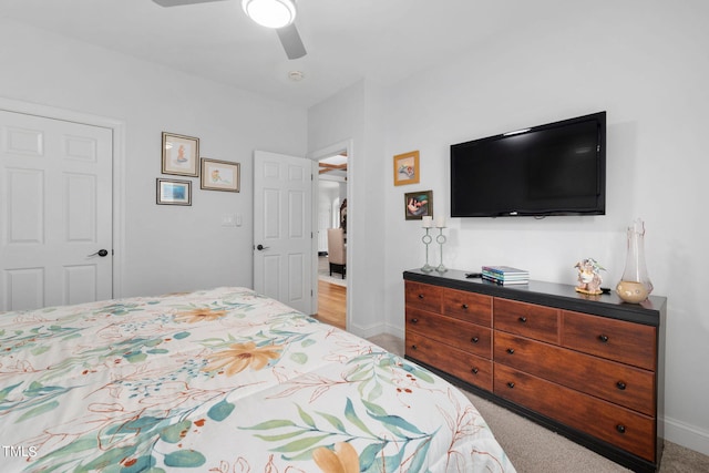 bedroom with ceiling fan and light colored carpet