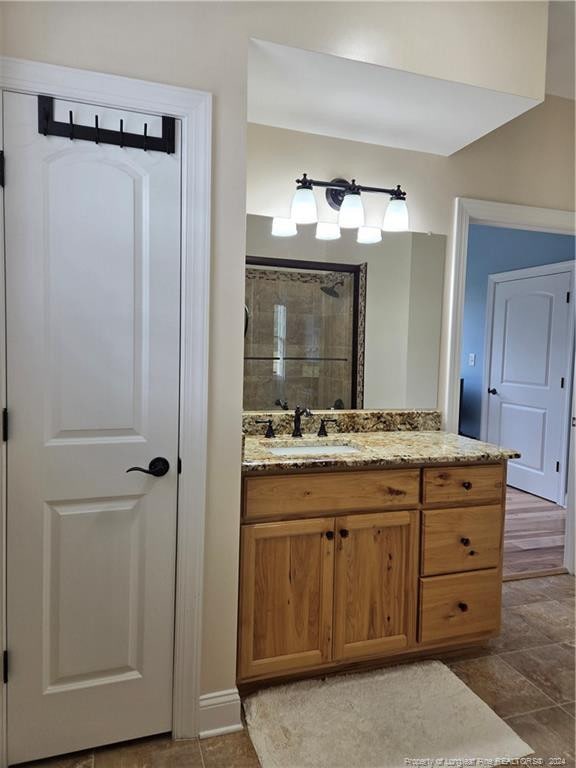 bathroom with tile flooring and vanity