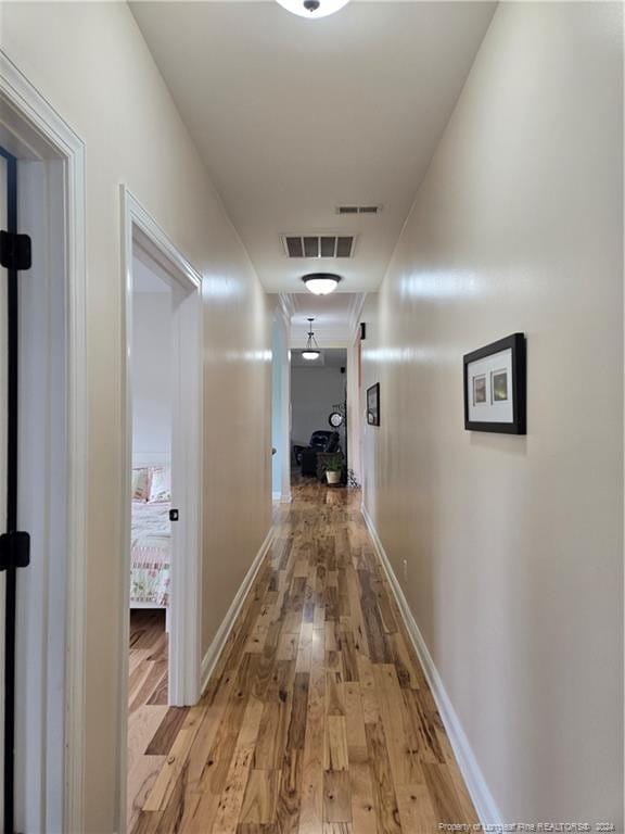 corridor with light hardwood / wood-style floors