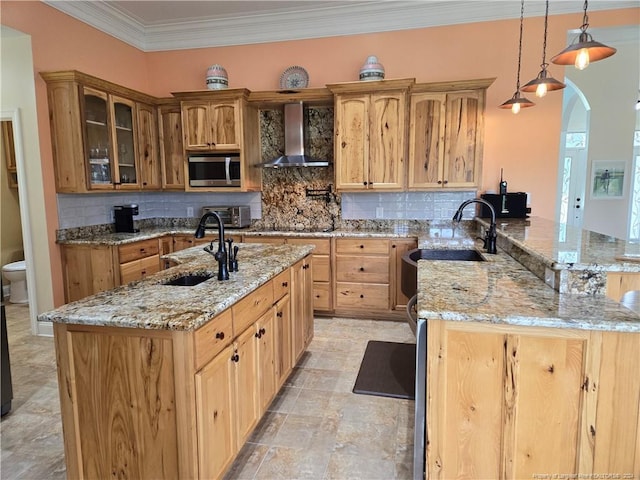 kitchen featuring backsplash, light tile flooring, sink, light stone counters, and wall chimney exhaust hood