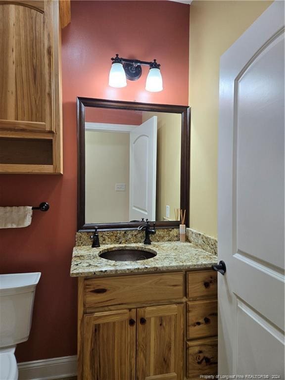 bathroom featuring toilet and vanity