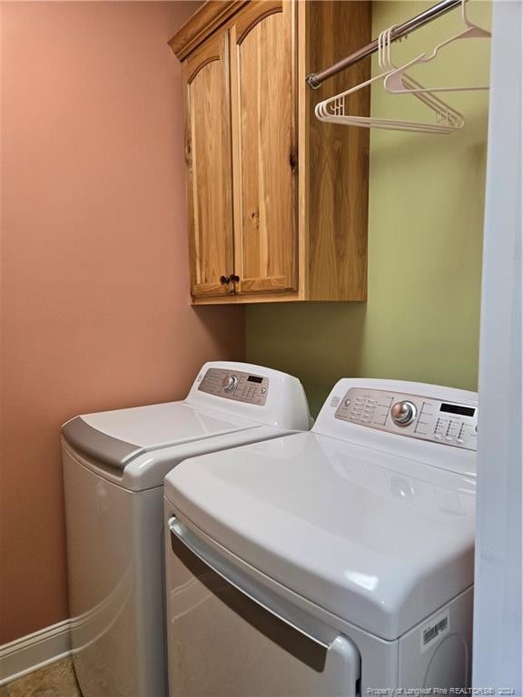 laundry area with cabinets and washer and clothes dryer